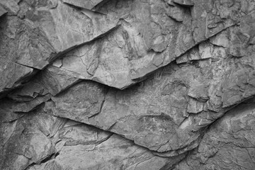 Black white rock background. Rocky stone surface texture. Gray rough background. Grunge.