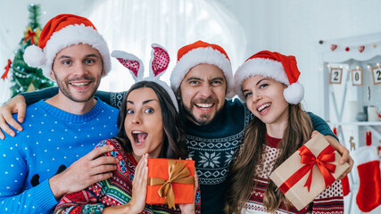 Joyful friends celebrating Christmas at home