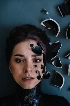 Portrait Of A Beautiful Young Woman With Broken Glass On Face