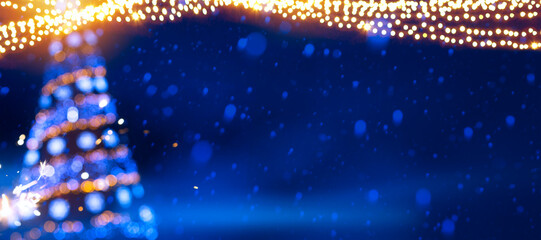 A Christmas tree lights on blue snow background