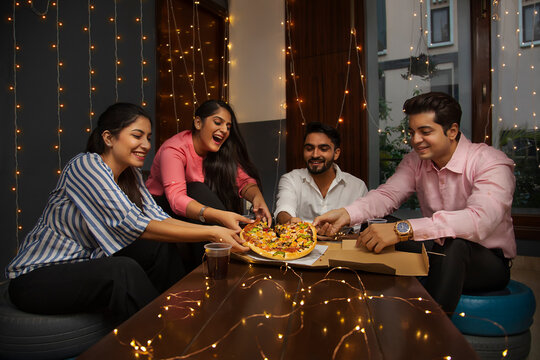 A GROUP OF HAPPY COLLEGUES SHARING A PIZZA	