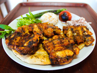Grilled chicken wings with vegetables on a plate