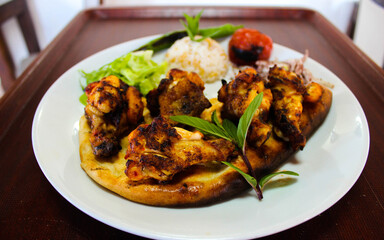 Grilled chicken wings with vegetables on a plate
