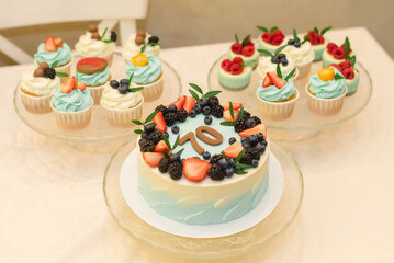 Cake and sweets on the anniversary with fruits and berries