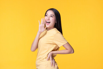 Image of feeling excited, shock, surprise and happy. Young asian woman standing on yellow...
