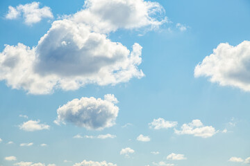 Fototapeta premium Blue sky background with white fluffy clouds in the fresh sunny day.