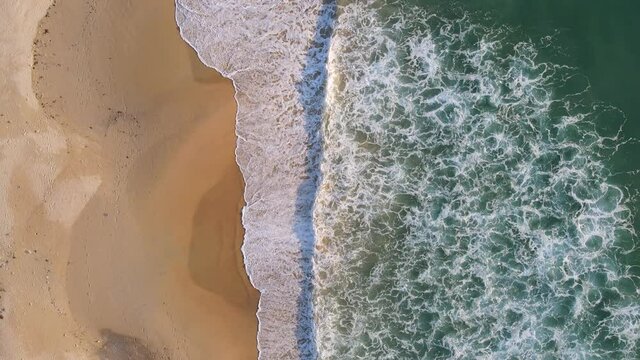 Drone shot Aerial view of the sunsets over sea. Beautiful sea waves. Beach sand and amazing sea. Summer sunset seascape. Phuket Thailand Beach. Water texture. Top view of the fantastic natural sunsets
