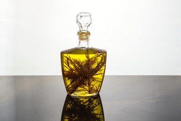 still life glass decanter with olive oil flavored with herbs and spices