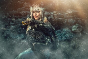 beautiful shamanic woman with eagle in the nature.