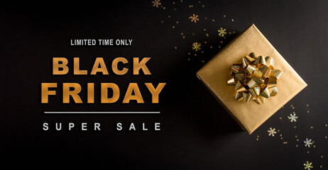 Fototapeta na wymiar Top view of golden christmas gift boxes on black background with Black Friday text. Black Friday Sale, Banner, poster composition.