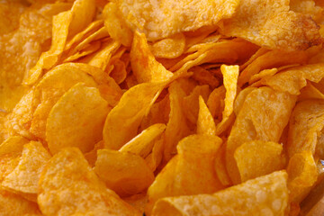 Potato chips or crisps . Close-up of potato chips or crisps. Food background.