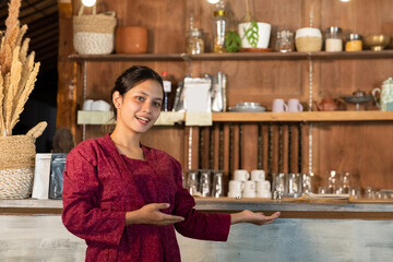 portrait of a young woman selling traditional coffee drinks