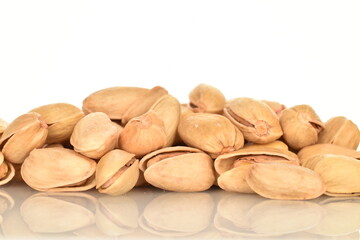 Delicious pistachios, close-up, on a white background.