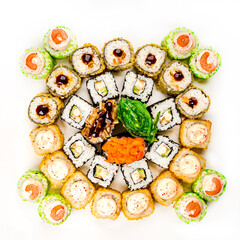 Japanese rolls on a plate and soy sauce isolated on a white background close-up. horizontal photo.