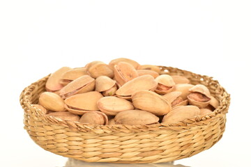 Delicious pistachios, close-up, on a white background.