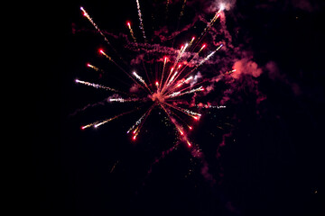 Fototapeta na wymiar red fireworks exploding on the night 2021 new year celebration