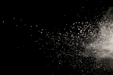 Freeze motion of white color powder exploding on black  background.