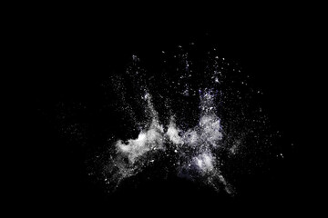 White powder or flour explosion isolated on black background.