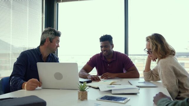 Mixed race group of business workers working together on collaboration project 