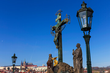 Fototapeta premium Autumn colorful Prague Lesser Town with gothic Castle from Charles Bridge with its baroque Sculpture, Czech Republic