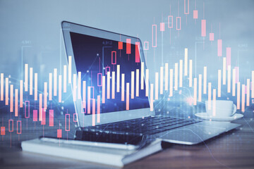 Stock market graph and table with computer background. Double exposure. Concept of financial analysis.