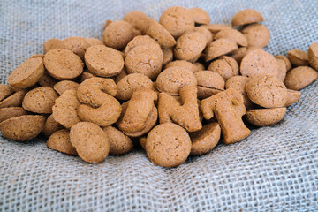 Dutch holiday Sinterklaas background with kruidnoten, traditional Sinterklaas sweets.. Pepernoten on sacking for sweets and gift boxes. Concept for children party Saint Nicolas day five december.