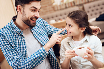 Father with Daughter Eating Cakes in Cafeteria.