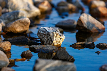 Stones in the water of Lake Imandra. Autumn landscape, Kola Peninsula, Russia.