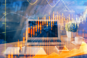 Financial graph colorful drawing and table with computer on background. Double exposure. Concept of...