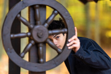 Portrait with a handsome young man in autumn forest, fashion concept.