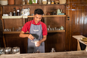 portrait young man make the drink milk coffee
