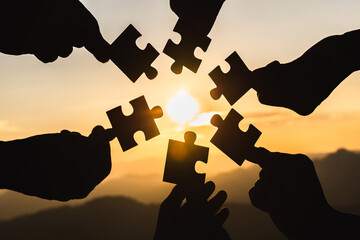 Silhouette  hands connecting  jigsaw puzzle piece against sunrise, Business solutions,  teamwork,...