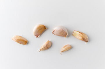 Pieces of raw garlic on isolated white background. Top view Garlic bulbs.