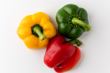 Colorful raw red yellow green of bell pepper above view on isolated white background. Healthy vegetables and food.
