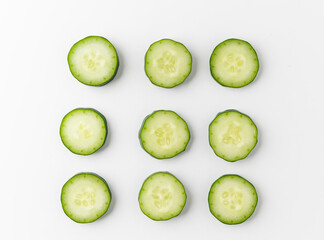 Pile Cucumber sliced into circle and arranging on white table isolated background. Healthy vegetables and food.