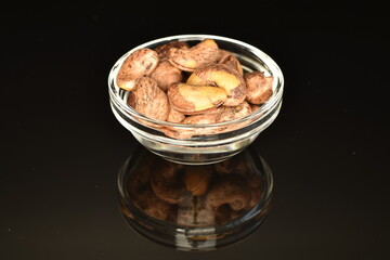Fragrant roasted cashews, close-up, on a black background.