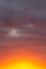 Wonderful November sunset with bright red-pink clouds on a dark gray-blue sky