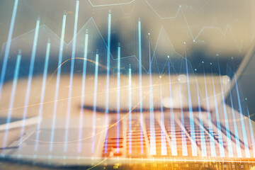 Financial graph colorful drawing and table with computer on background. Multi exposure. Concept of...