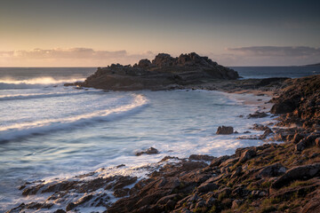 sunset over the ruins of Castro of Baroña in Galicia