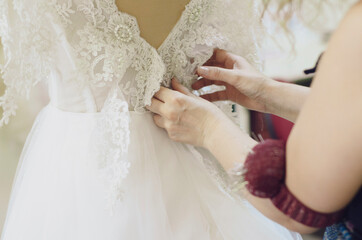Fashion designer sews wedding dresses