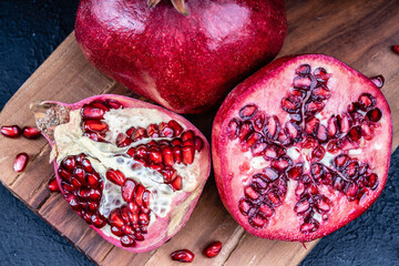 Ripe and red pomegranate on wooden
