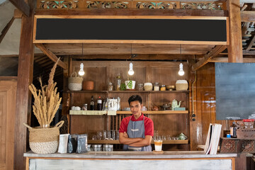 portrait of a young man selling traditional coffee drinks