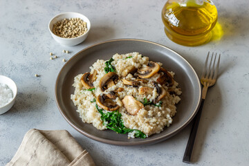 Risotto with mushrooms and spinach. Healthy food. Vegetarian food.