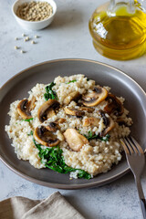 Risotto with mushrooms and spinach. Healthy food. Vegetarian food.