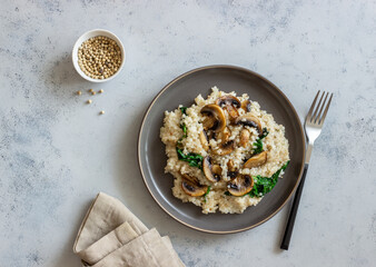 Risotto with mushrooms and spinach. Healthy food. Vegetarian food.