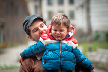 Fototapeta premium 2 years old toddler in the park with his father in a cloudy London day