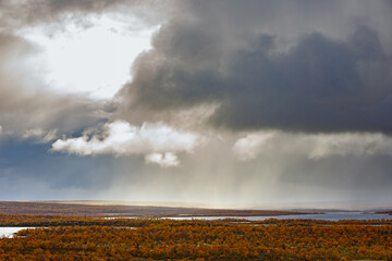 Fototapeta na wymiar Streams of rain from the clouds over the tundra in autumn.