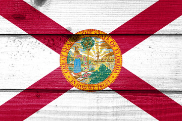 florida flag painted on old wood plank background. Brushed natural light knotted wooden board texture. Wooden texture background flag of florida