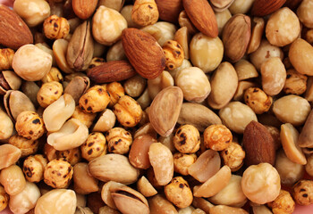 Mixed nuts and dried fruits, close up view, nuts background with almonds,hazelnut,pistachio mix