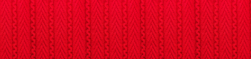 Knitted red background. The concept of a cozy new year and Christmas. Banner. Copy space.